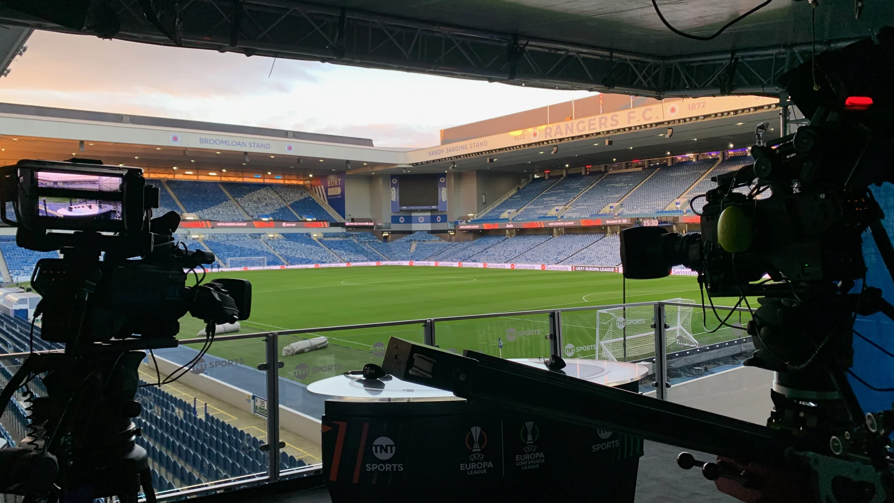 Broadcast cameras and monitors set up for a stadium production